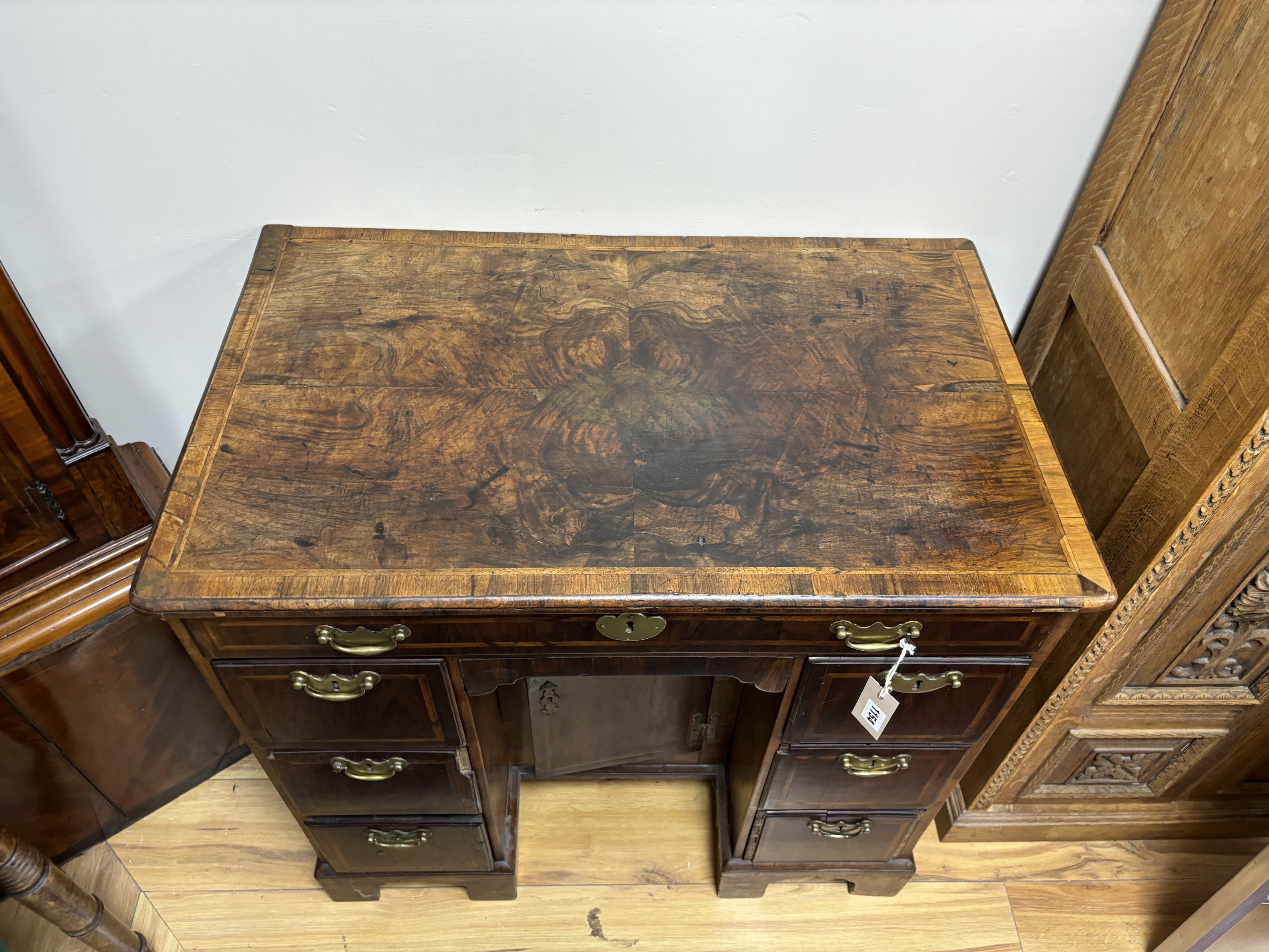 An 18th century banded walnut kneehole desk, width 80cm, depth 49cm, height 77cm